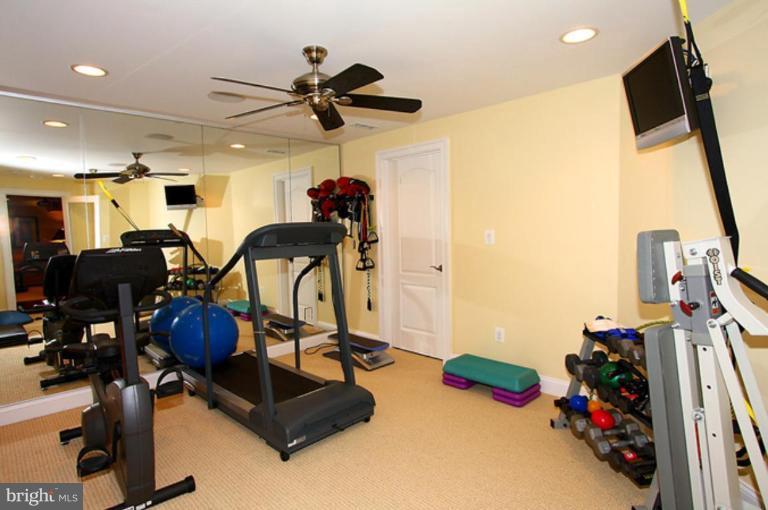 1441 Waterfront Road Reston, VA 20194 - Photo 30 of 30 a room with gym equipment and a flat screen tv