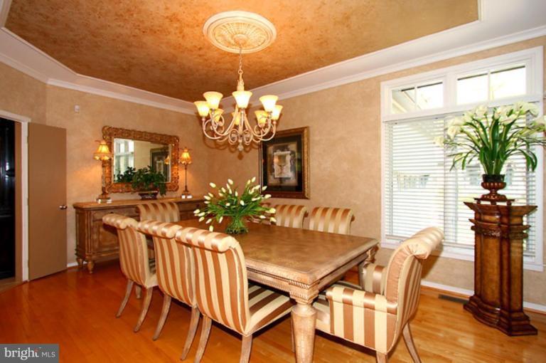 1441 Waterfront Road Reston, VA 20194 - Photo 10 of 30 a view of a dining room with furniture a chandelier and wooden floor