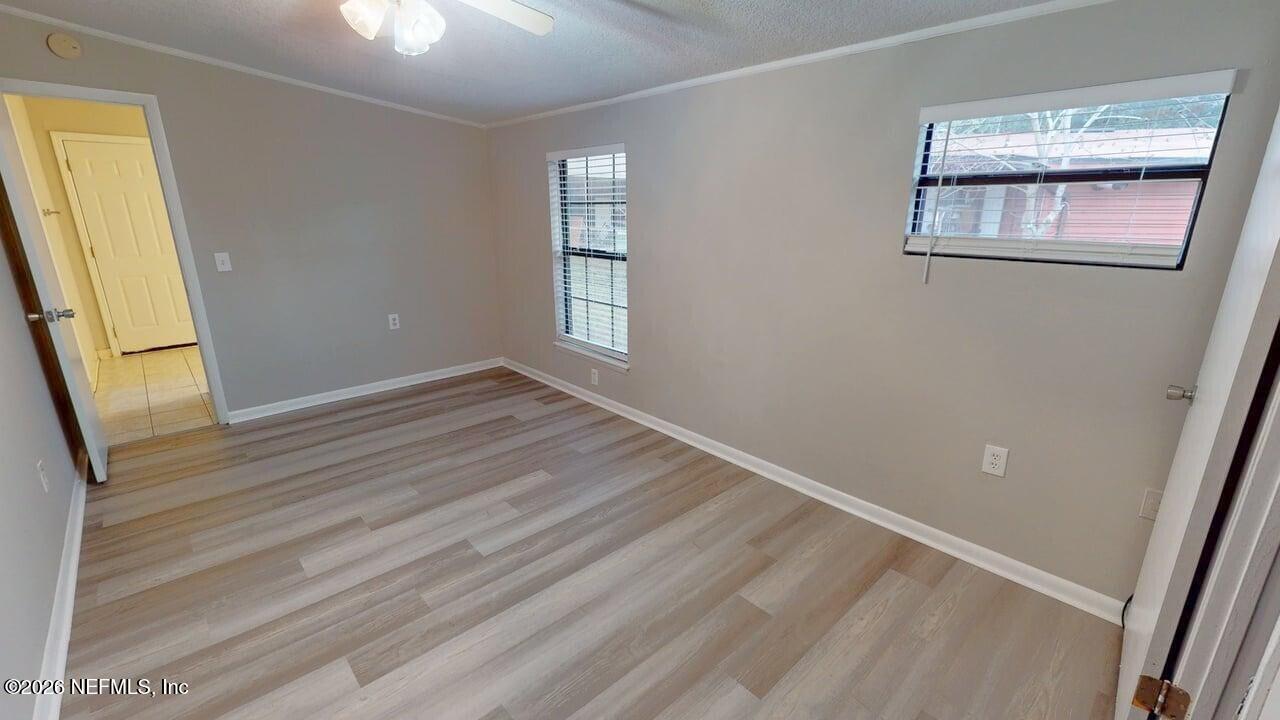 6713 Peter Rabbit Drive North Jacksonville, FL 32210 - Photo 16 of 24 a view of an empty room with wooden floor and a window
