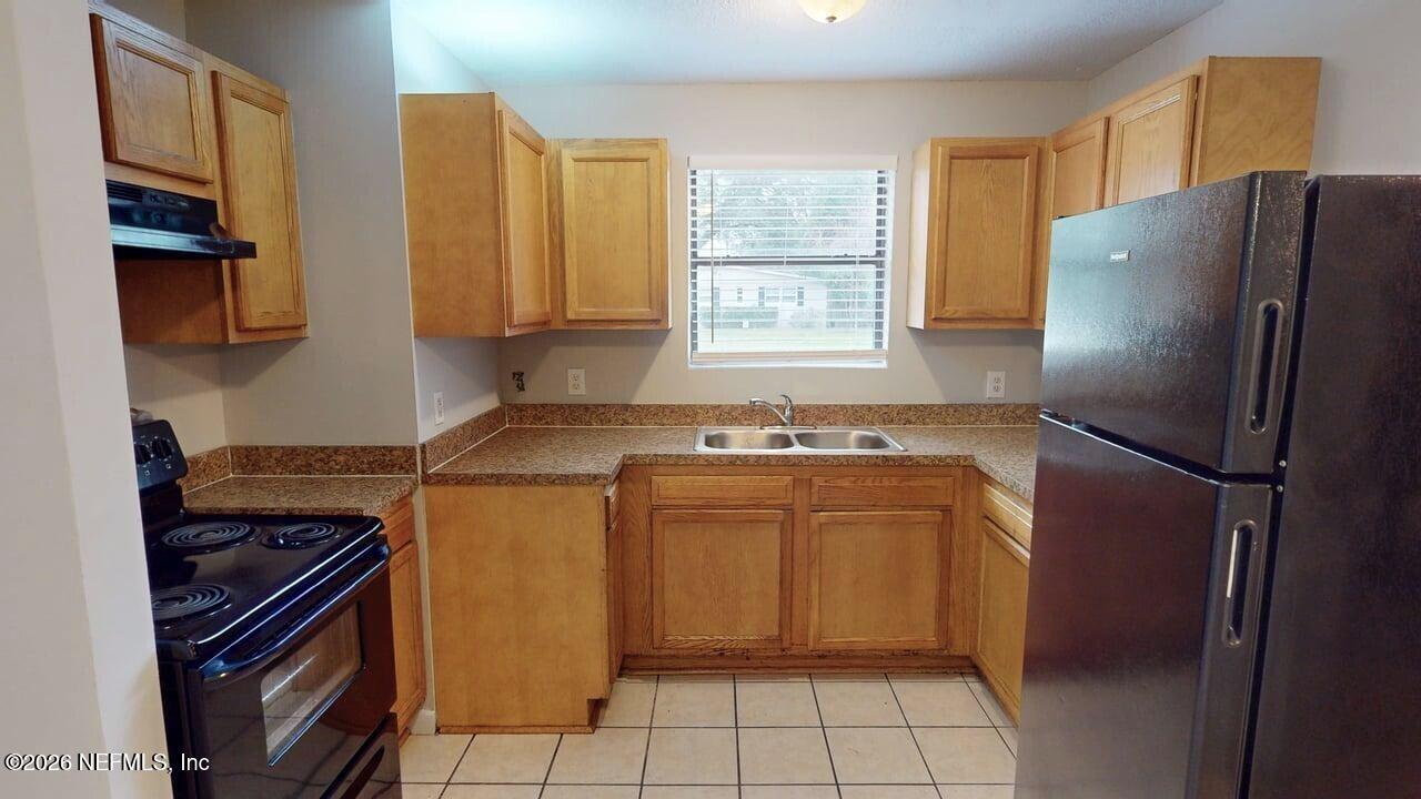 6713 Peter Rabbit Drive North Jacksonville, FL 32210 - Photo 5 of 24 a kitchen with a refrigerator and a sink