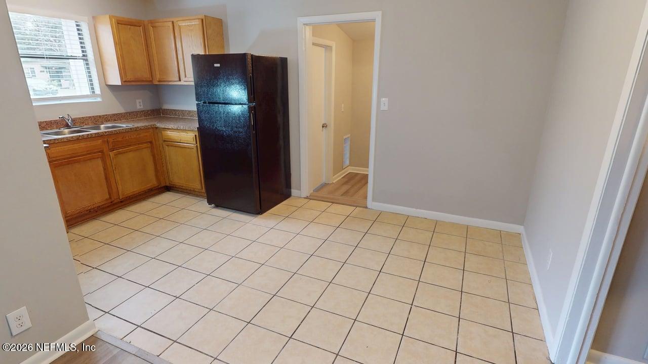6713 Peter Rabbit Drive North Jacksonville, FL 32210 - Photo 7 of 24 a kitchen with stainless steel appliances granite countertop a refrigerator and a stove