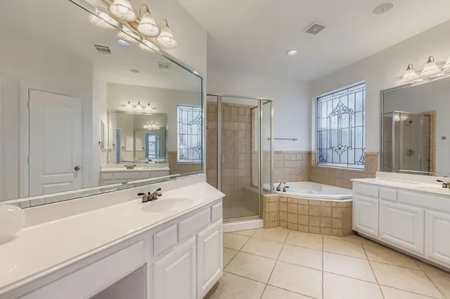a bathroom with a double vanity sink mirror and