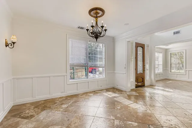 a view of a hallway with a chandelier