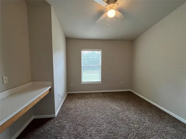 a view of room with window and ceiling fan