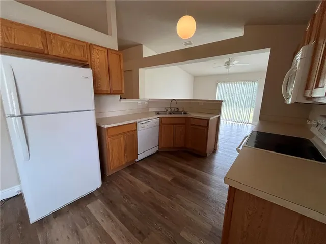 a kitchen with stainless steel appliances a refrigerator and a stove