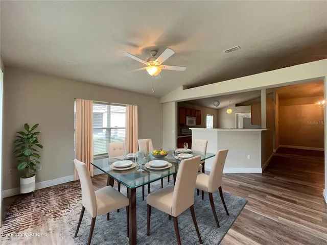 a view of a dining room with furniture window and wooden floor