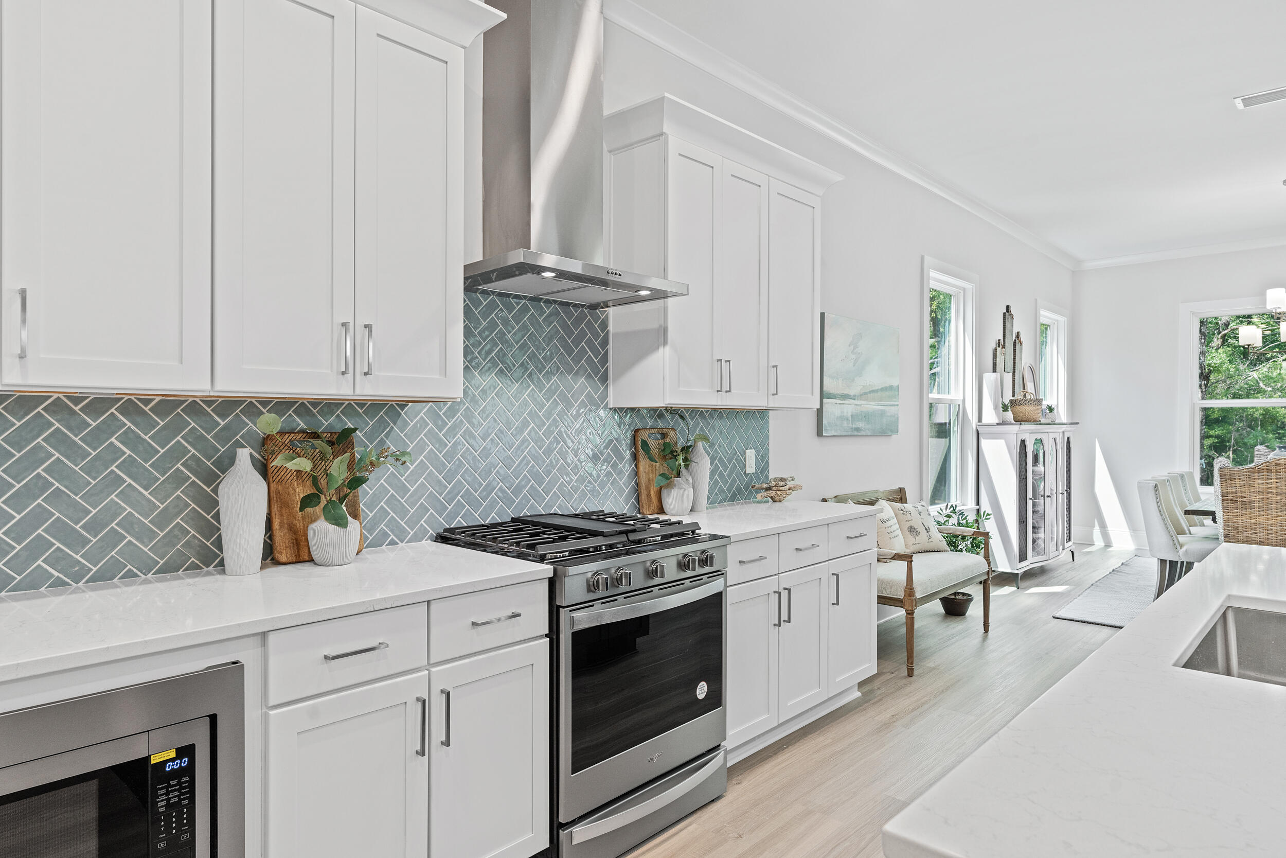 20 Mackenzie Lane, Unit LOT 34 Freeport, FL 32439 - Photo 19 of 50 a kitchen with stainless steel appliances white cabinets and a stove top oven