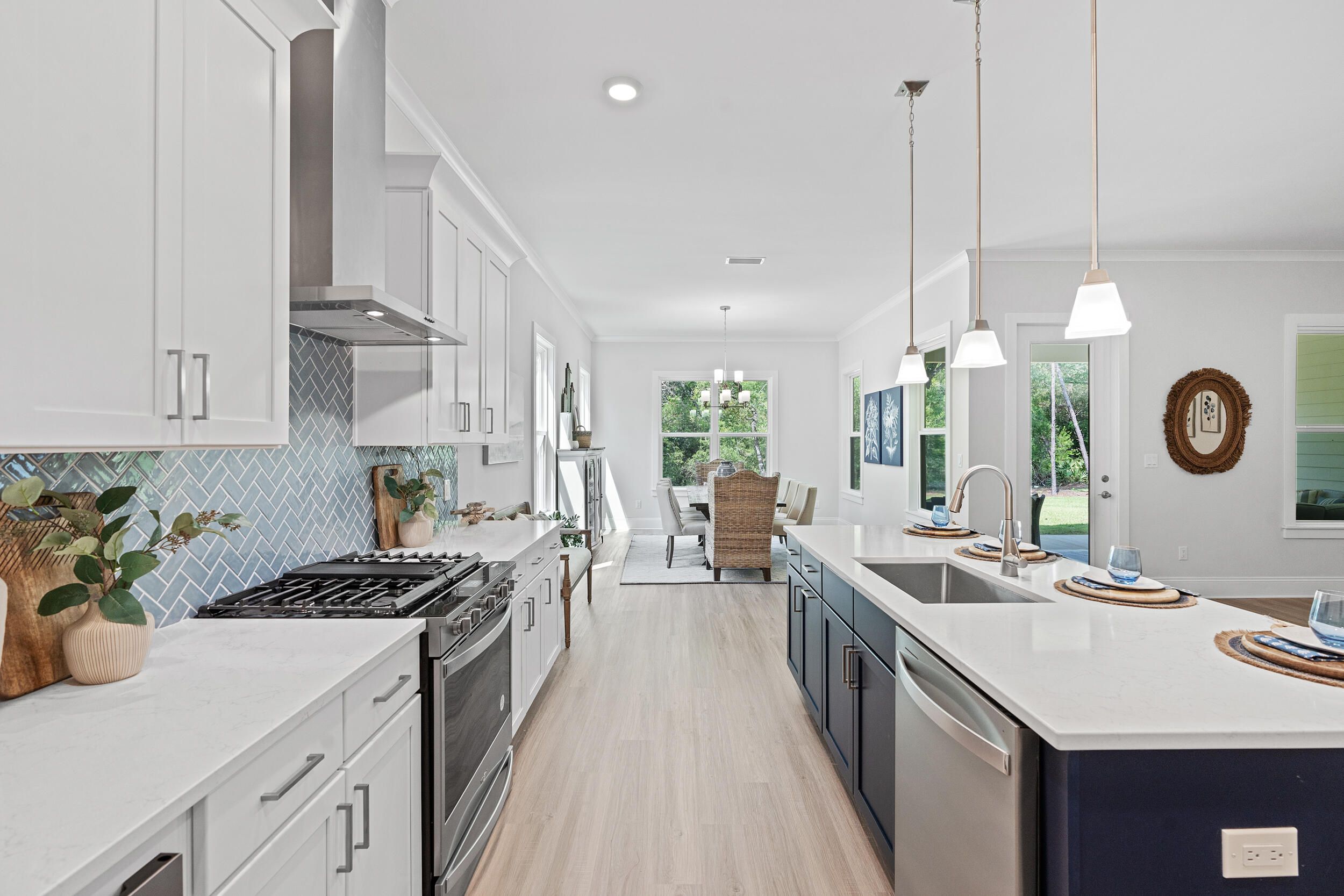 20 Mackenzie Lane, Unit LOT 34 Freeport, FL 32439 - Photo 20 of 50 a kitchen with kitchen island granite countertop a sink a counter space and stainless steel appliances
