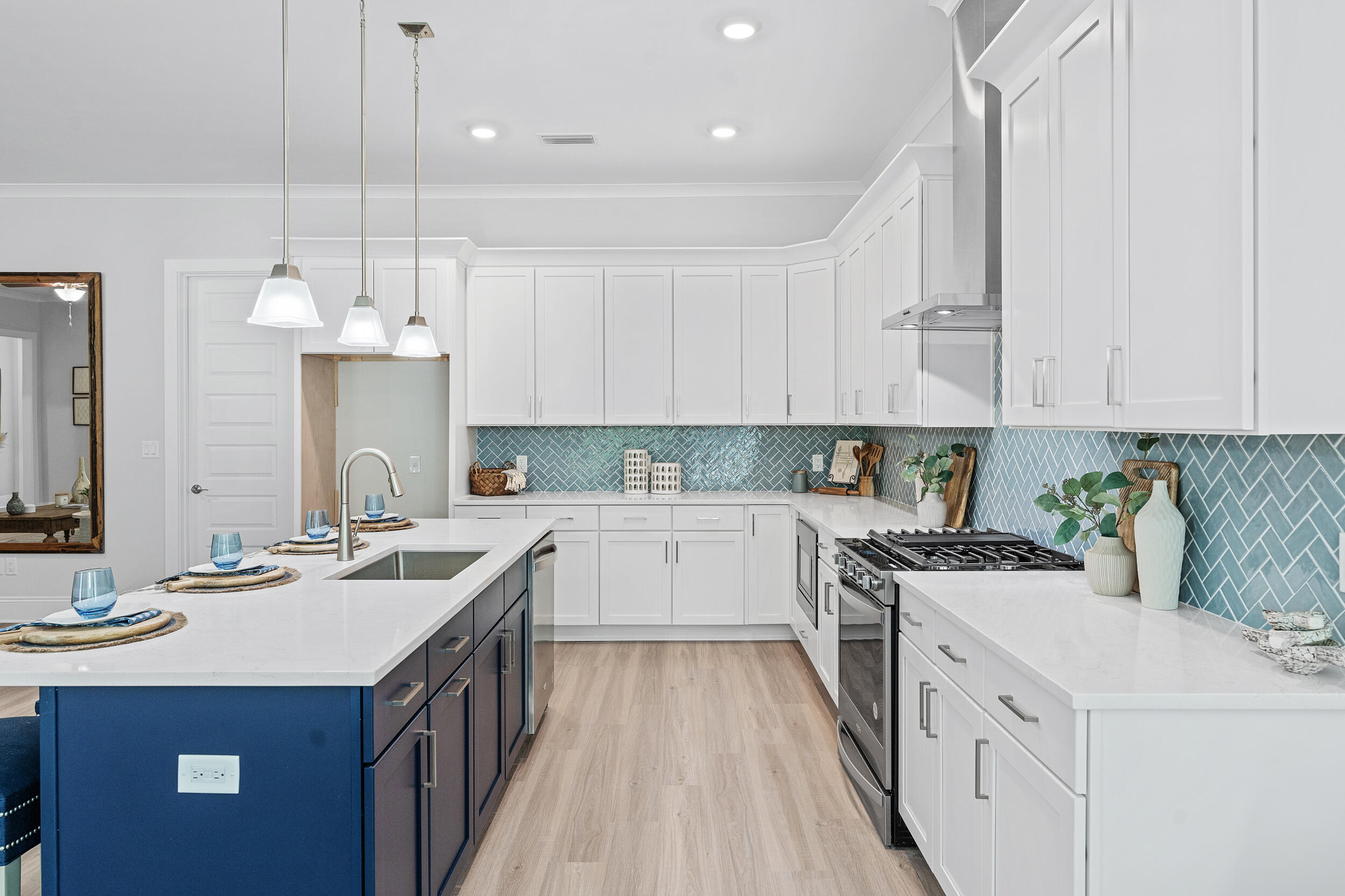 20 Mackenzie Lane, Unit LOT 34 Freeport, FL 32439 - Photo 22 of 50 a kitchen with a sink stove and white cabinets