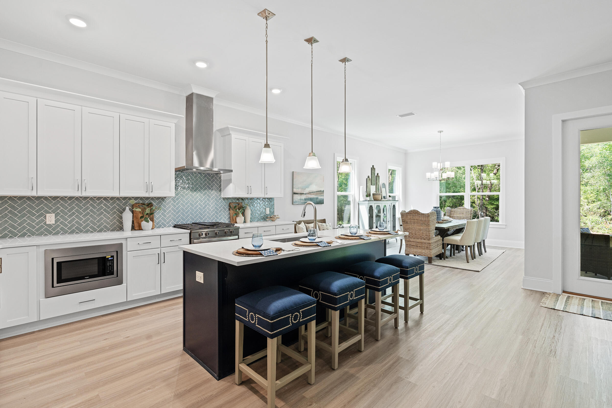 20 Mackenzie Lane, Unit LOT 34 Freeport, FL 32439 - Photo 24 of 50 a kitchen with a table chairs stove and wooden floor
