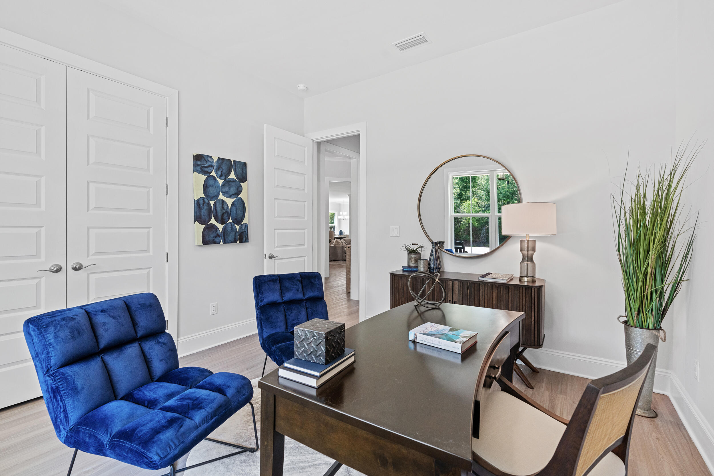 20 Mackenzie Lane, Unit LOT 34 Freeport, FL 32439 - Photo 25 of 50 a living room with furniture a potted plant and a wooden floor