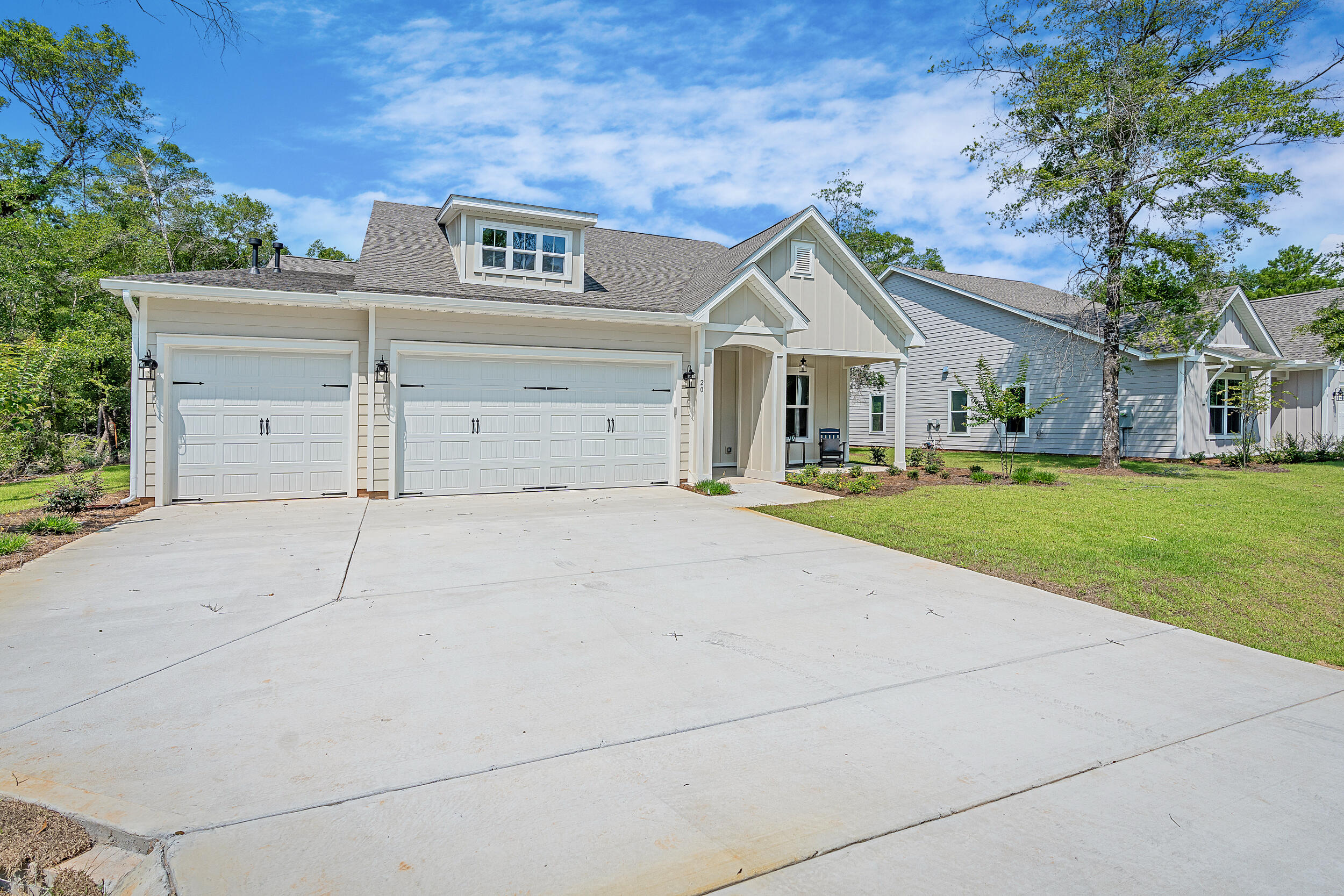 20 Mackenzie Lane, Unit LOT 34 Freeport, FL 32439 - Photo 3 of 50 a front view of a house with a yard and garage