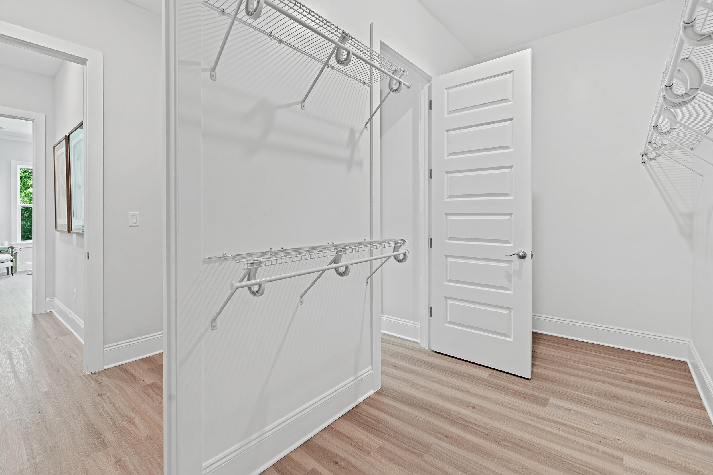 20 Mackenzie Lane, Unit LOT 34 Freeport, FL 32439 - Photo 37 of 50 a view of walk in closet with wooden floor