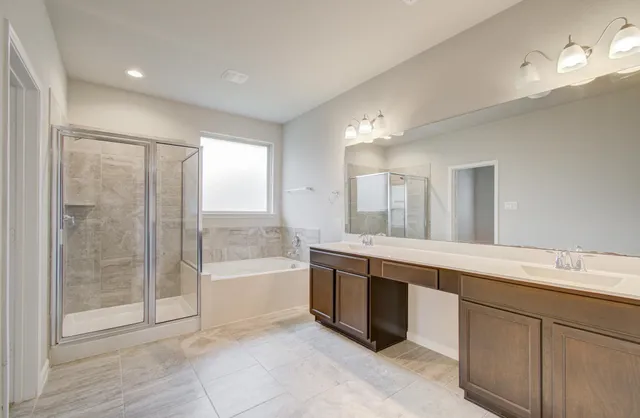a large bathroom with a large mirror vanity and shower