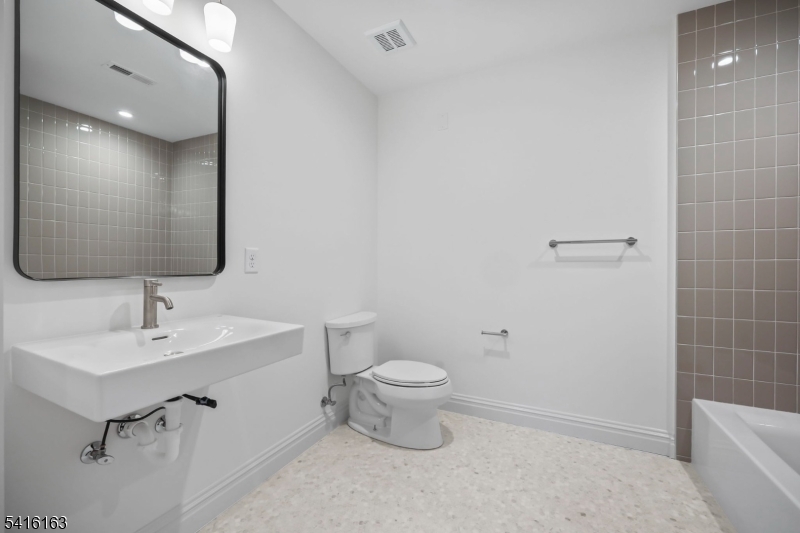 1209 Littleton Road, Unit B Morris Plains, NJ 07950 - Photo 15 of 19 a bathroom with a sink toilet and shower