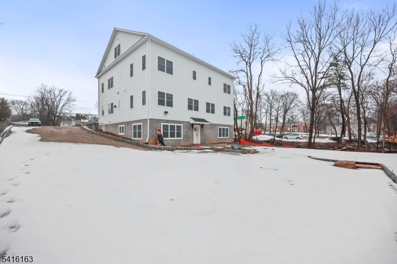 1209 Littleton Road, Unit B Morris Plains, NJ 07950 - Photo 18 of 19 a view of a building with snow on the road