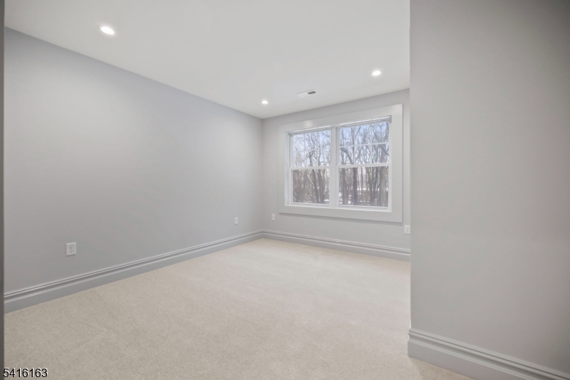 1209 Littleton Road, Unit B Morris Plains, NJ 07950 - Photo 4 of 19 a view of an empty room with a window