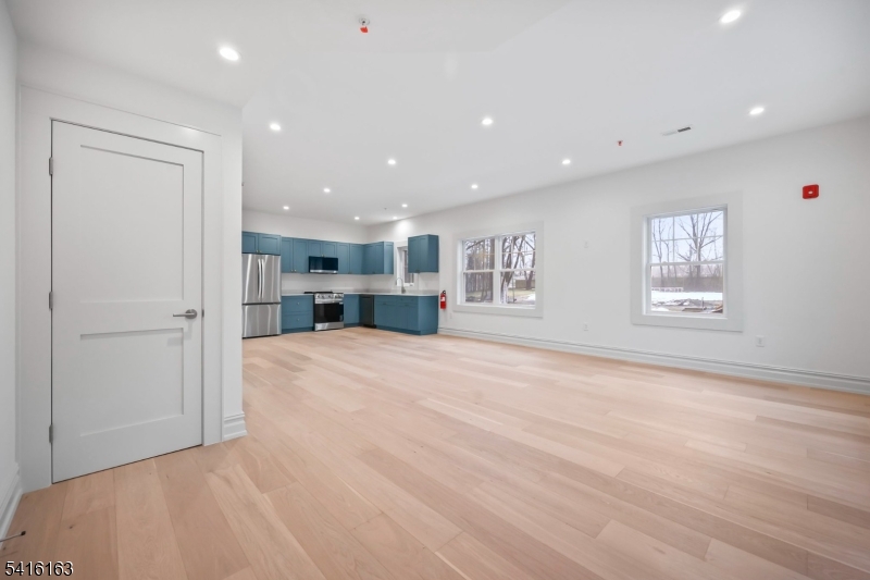 1209 Littleton Road, Unit B Morris Plains, NJ 07950 - Photo 5 of 19 a view of empty room with kitchen and window