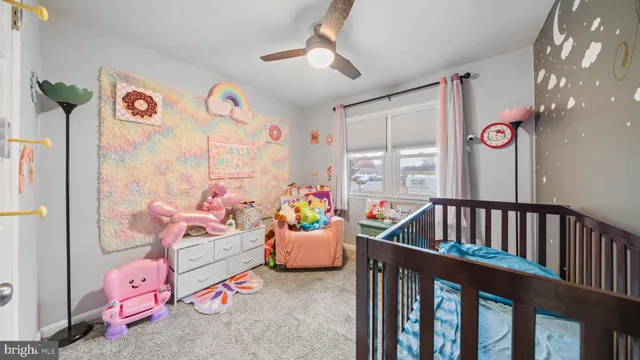 a bedroom with furniture and a large window