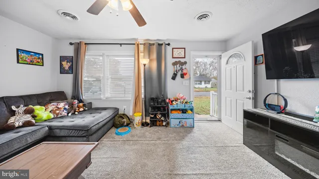 a living room with furniture and flat screen tv