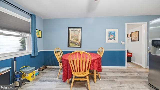 a view of a dining room with furniture and wooden floor