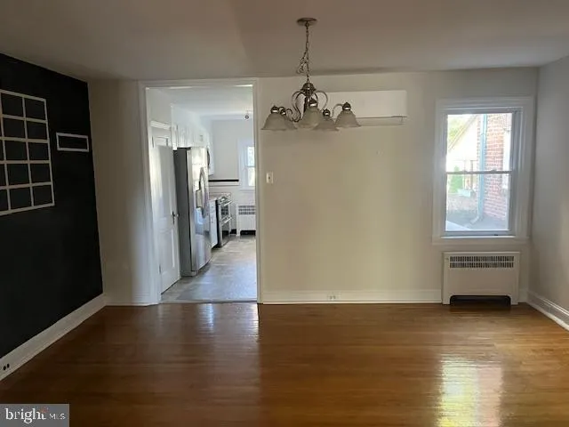 a view of a room with wooden floor and windows