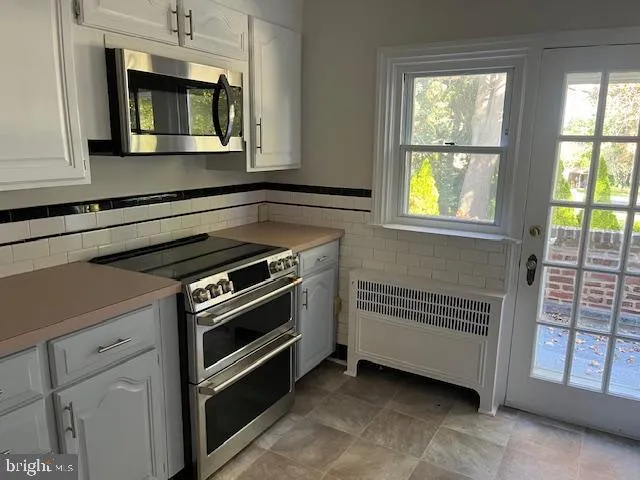 a kitchen with a stove and a microwave