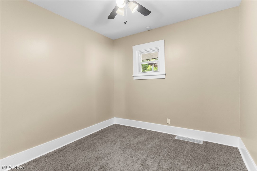 403 Mosier Road Girard, OH 44420 - Photo 17 of 22 Unfurnished room with dark carpet and ceiling fan