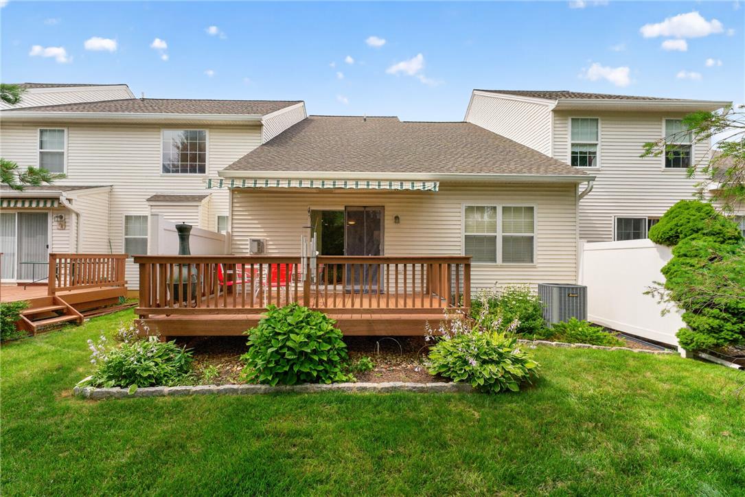 198 Park Ridge Drive Easton, PA 18040 - Photo 24 of 28 A well-maintained lawn stretches before a wooden deck, ideal for outdoor gatherings.