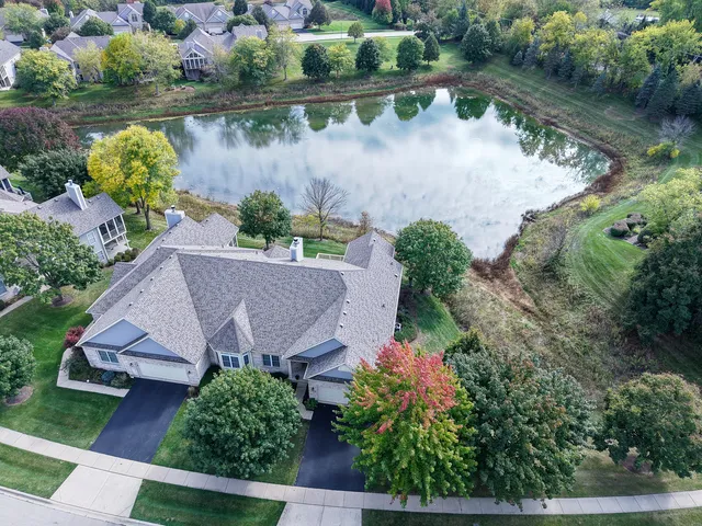 an aerial view of a house with a lake view