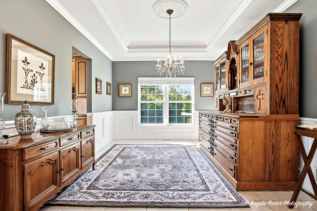 a kitchen with stainless steel appliances granite countertop a stove top oven a sink a window and dining table