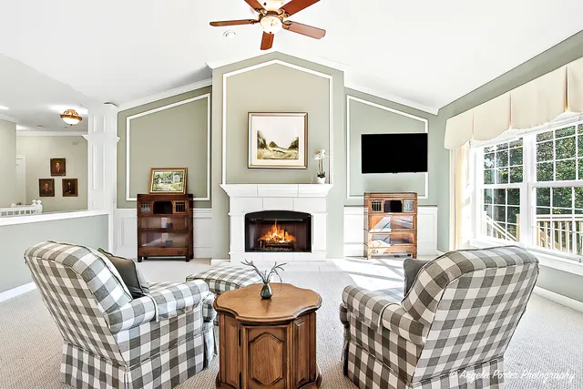 a living room with furniture a fireplace and a flat screen tv