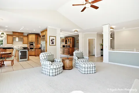 a living room with furniture and kitchen view