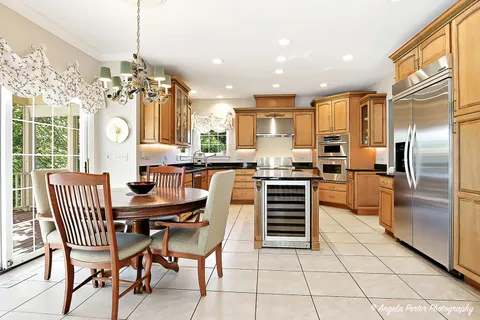 a large kitchen with a table and chairs