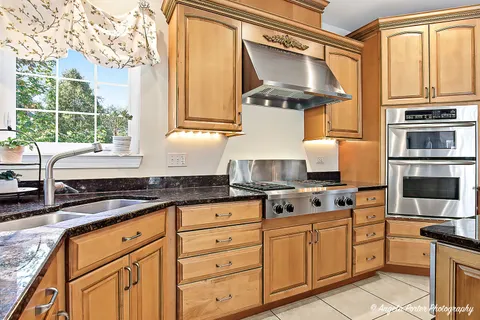 a kitchen with stainless steel appliances granite countertop a stove and a sink