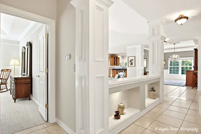 a large white kitchen with cabinets and wooden floor