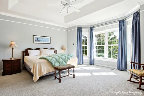 a spacious bedroom with a bed and a large window