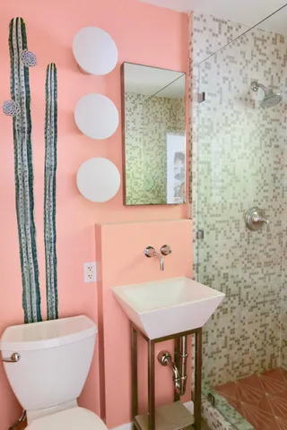 a bathroom with a sink a toilet and mirror