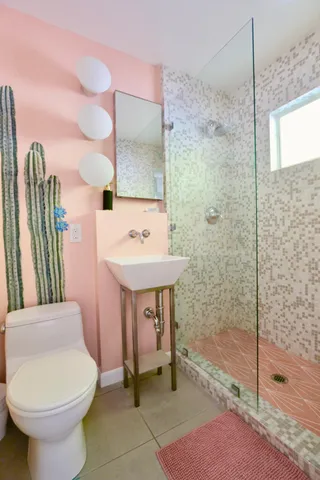 a bathroom with a sink toilet and shower