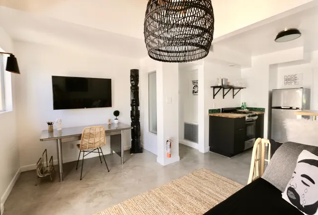 a view of a livingroom with furniture and flat screen tv