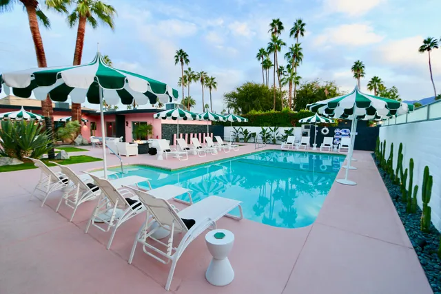 an aerial view of a house with swimming pool garden and patio