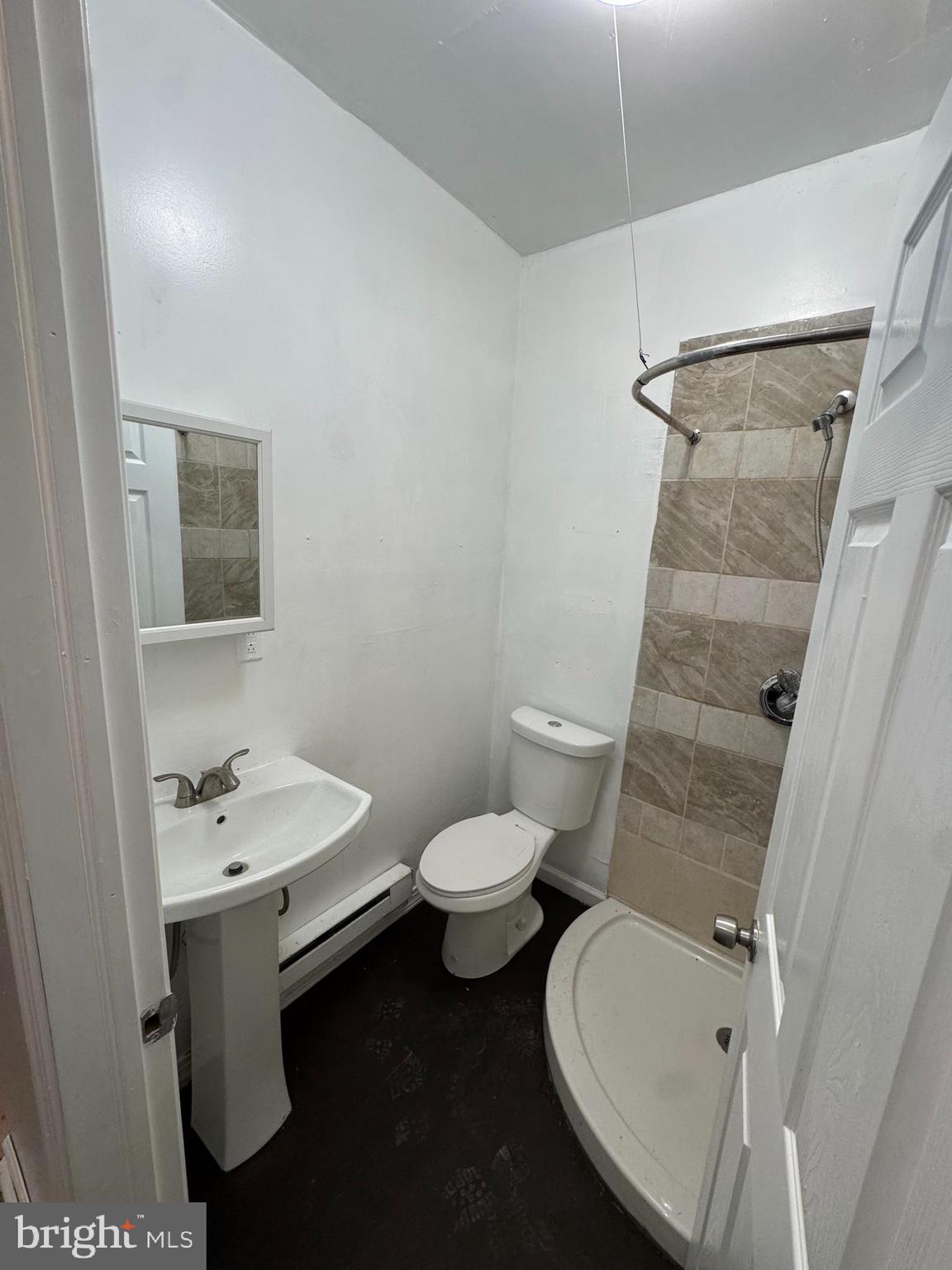 5677 Diamond Street Philadelphia, PA 19131 - Photo 2 of 7 a bathroom with a sink and mirror with toilet