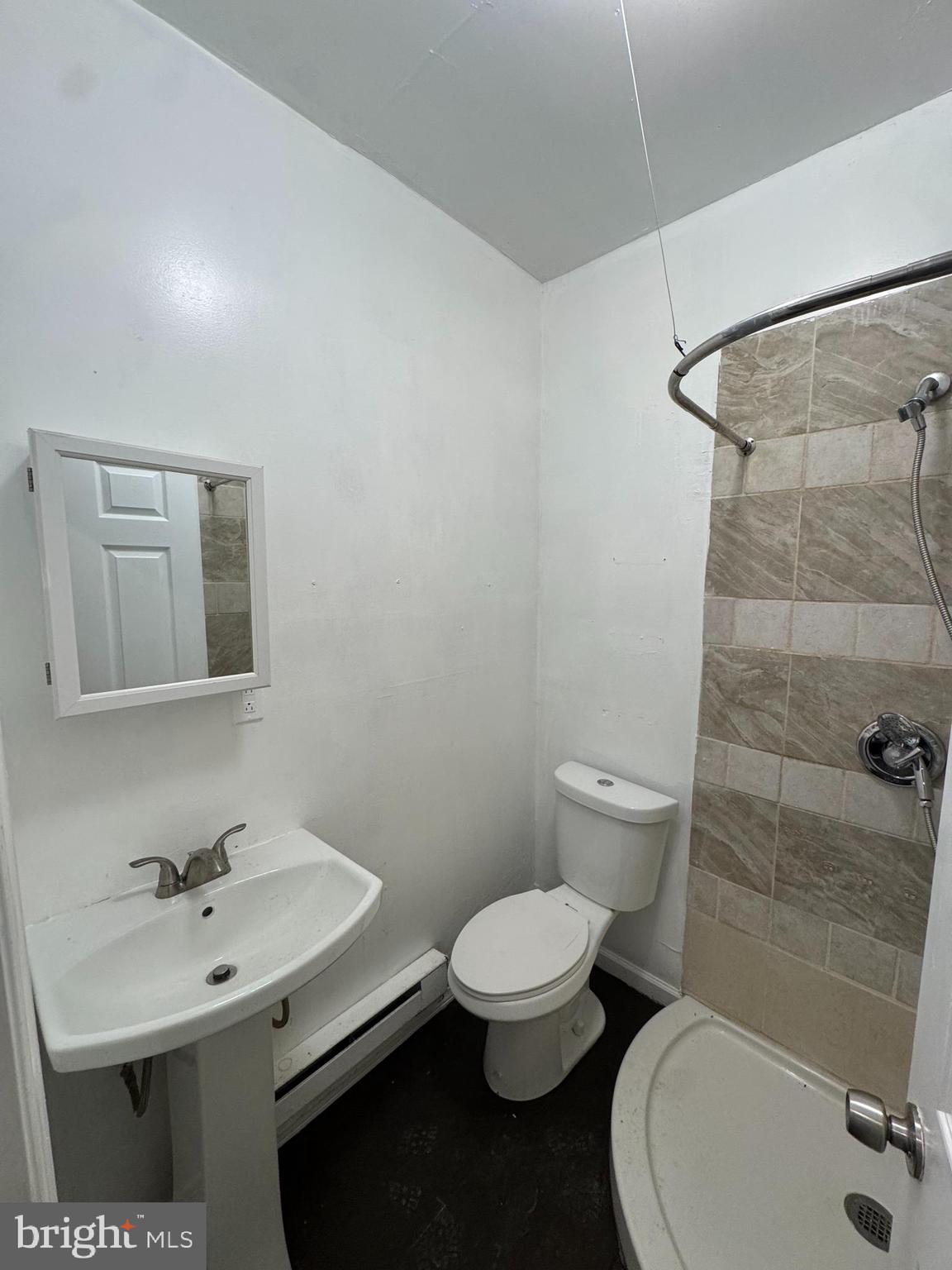 5677 Diamond Street Philadelphia, PA 19131 - Photo 3 of 7 a bathroom with a sink a toilet and shower