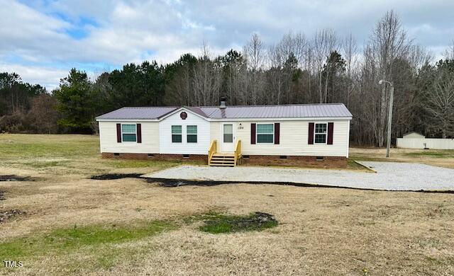 1199 Adams Mountain Road Stem, NC 27581 - Photo 2 of 34 a view of a white house with a yard