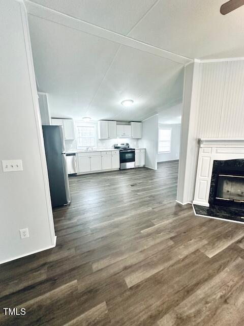 1199 Adams Mountain Road Stem, NC 27581 - Photo 24 of 34 a view of empty room with wooden floor and fireplace