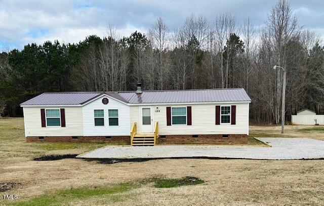 1199 Adams Mountain Road Stem, NC 27581 - Photo 4 of 34 a front view of a house with a yard and trees