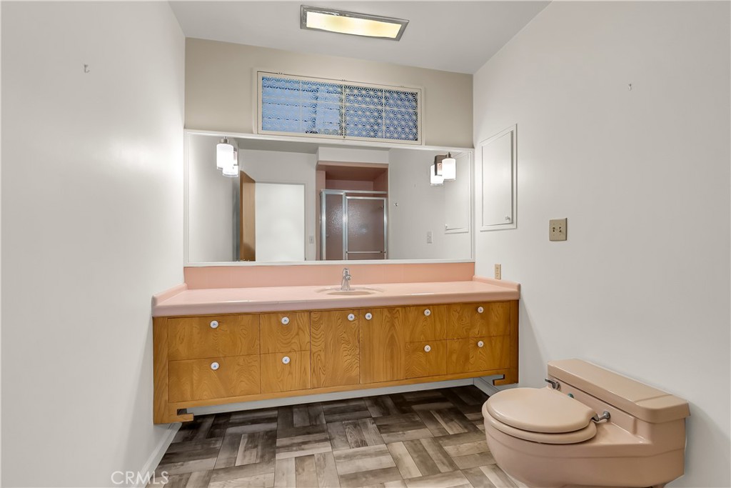 4907 Cliffside Drive Riverside, CA 92506 - Photo 16 of 29 a spacious bathroom with a granite countertop toilet a sink and a mirror