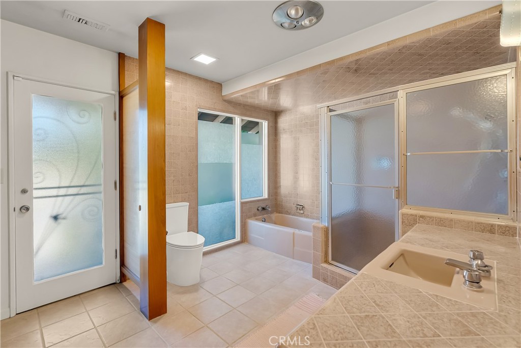 4907 Cliffside Drive Riverside, CA 92506 - Photo 18 of 29 a bathroom with a tub and shower