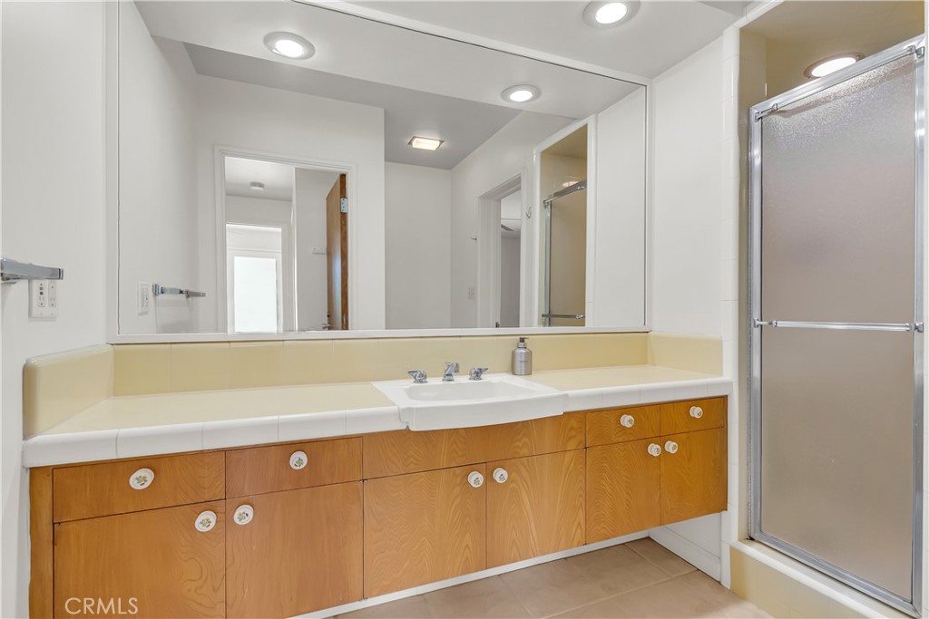 4907 Cliffside Drive Riverside, CA 92506 - Photo 20 of 29 a bathroom with a double vanity sink and mirror