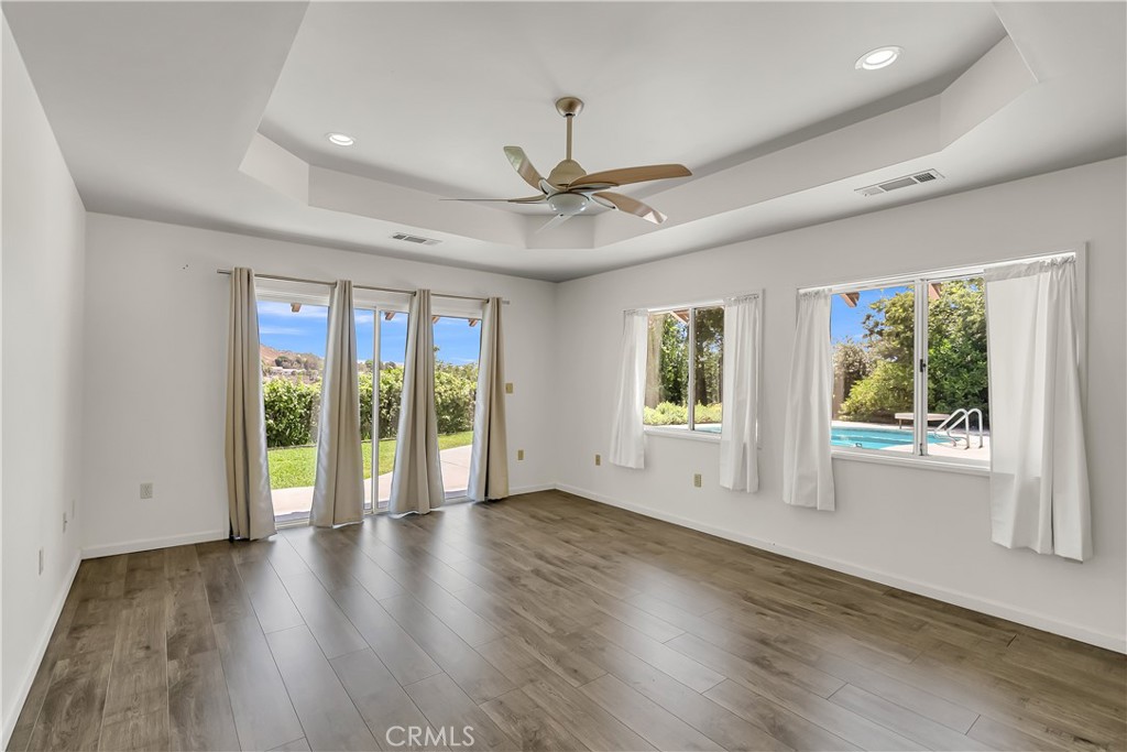 4907 Cliffside Drive Riverside, CA 92506 - Photo 22 of 29 a view of an empty room with wooden floor and a window